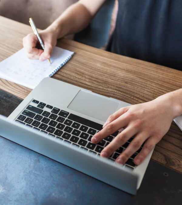 person-working-laptop-wooden-table